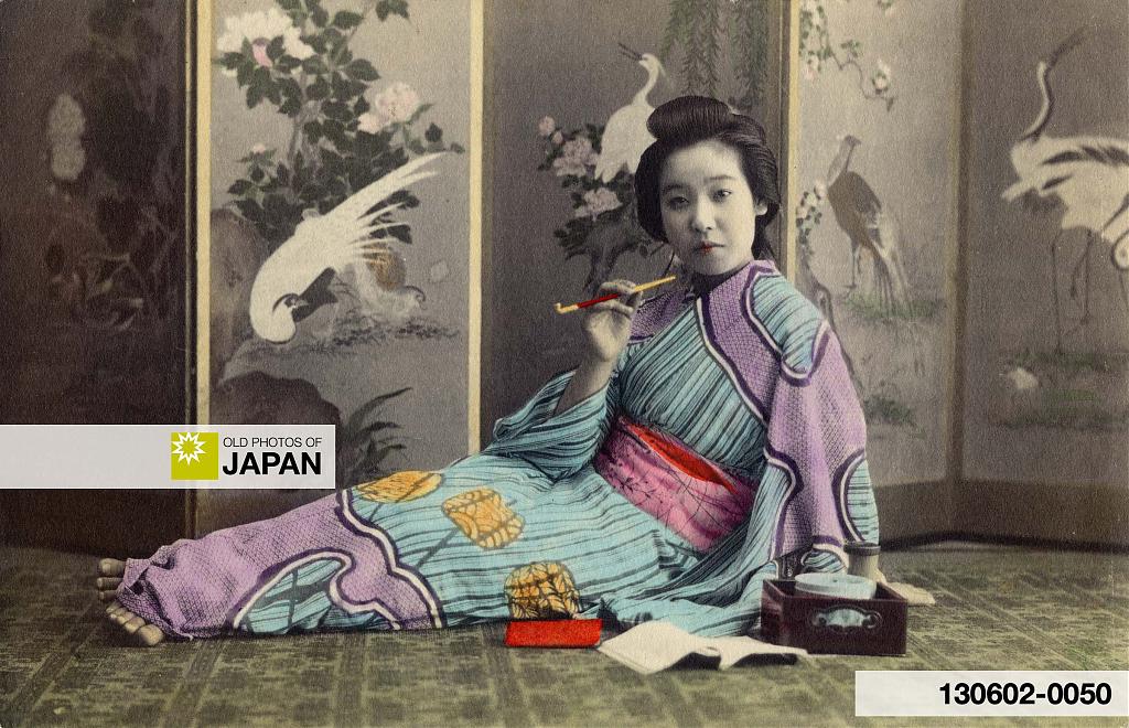 Japanese woman holding a kiseru pipe, 1900s