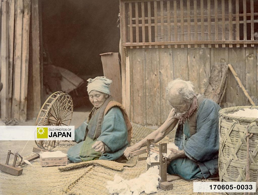 Elderly Japanese couple spinning cotton outside their home, 1890s