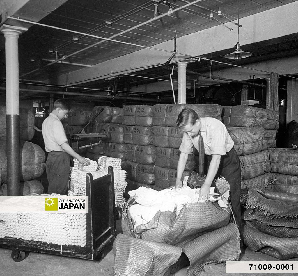 Opening bales of raw silk at a warehouse in Manchester, Connecticut, USA, early 20th century