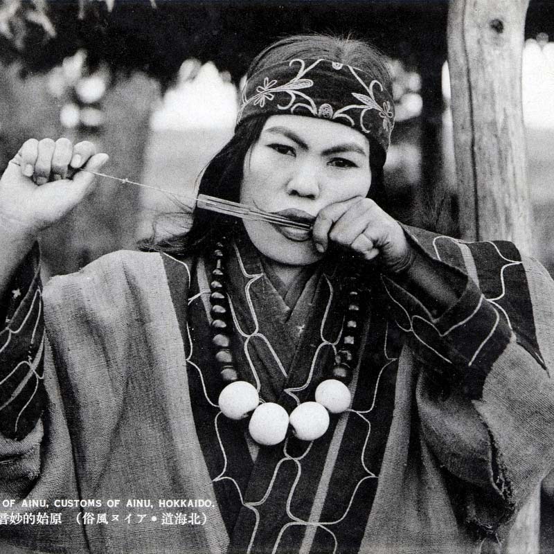 80201-0048 - Ainu woman playing the mukkuri